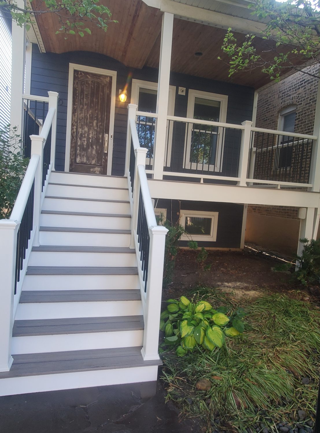 New front porch with composite stairs and painted railings